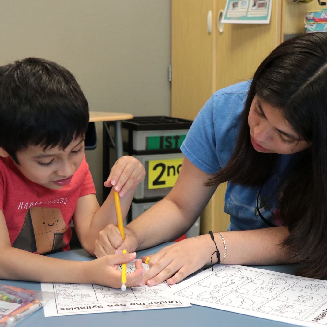  A student intern works with a student during Next Level Learning